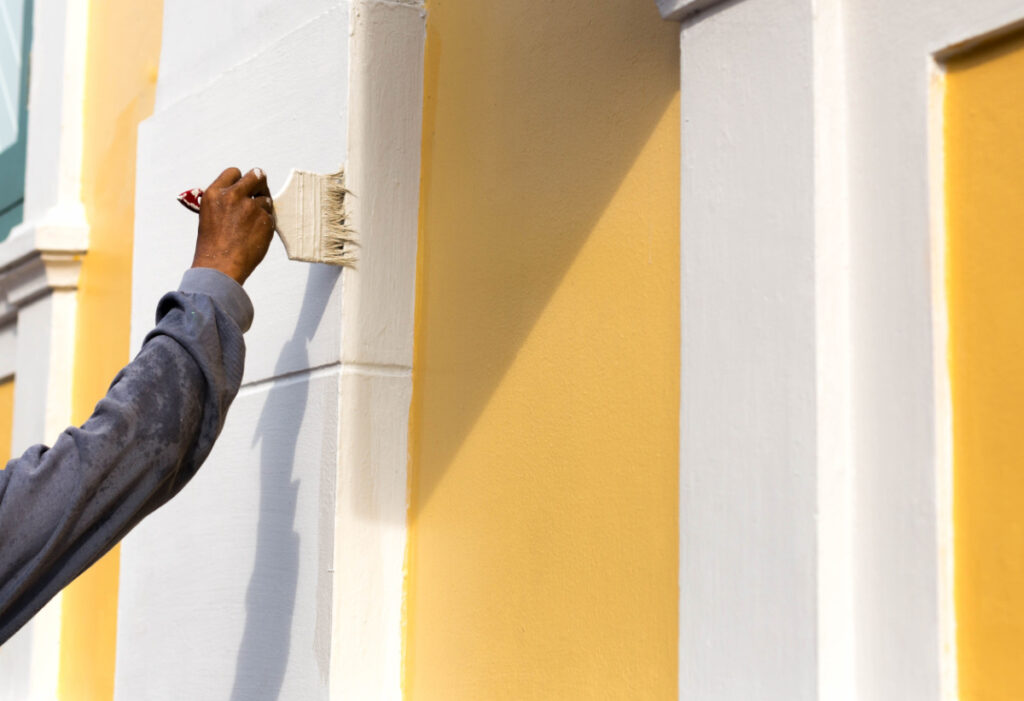 Professional painter painting the exterior of a home